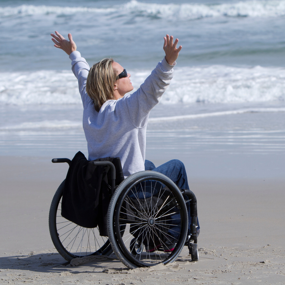 Woman is Wheelchair Celebrating at Beach